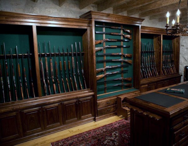 gun-collector-room-with-rifles-and-shotguns-mounted-on-wall-rack